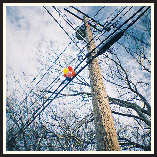Film photo of balloons stuck in a telephone wire in Austin, TX