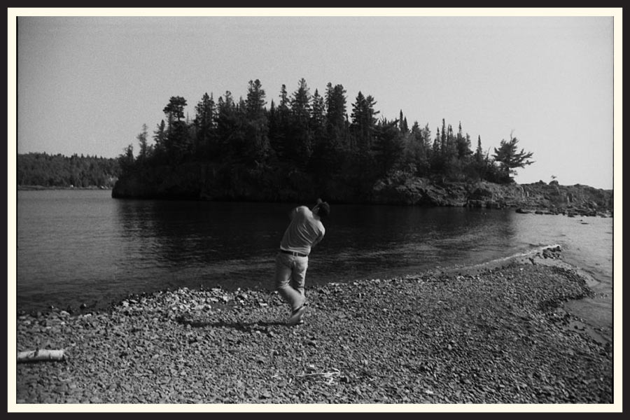 Film photo of someone skipping rocks in a river