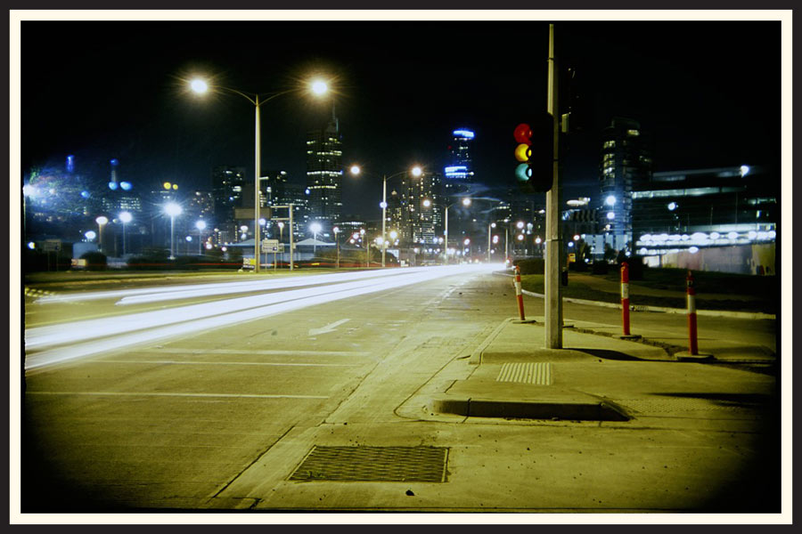 Film photo of the light trails of vehicles driving on a street in Melbourne.