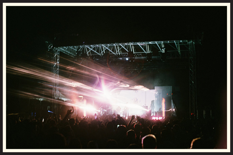 Film photo of the light show at a crowded concert.