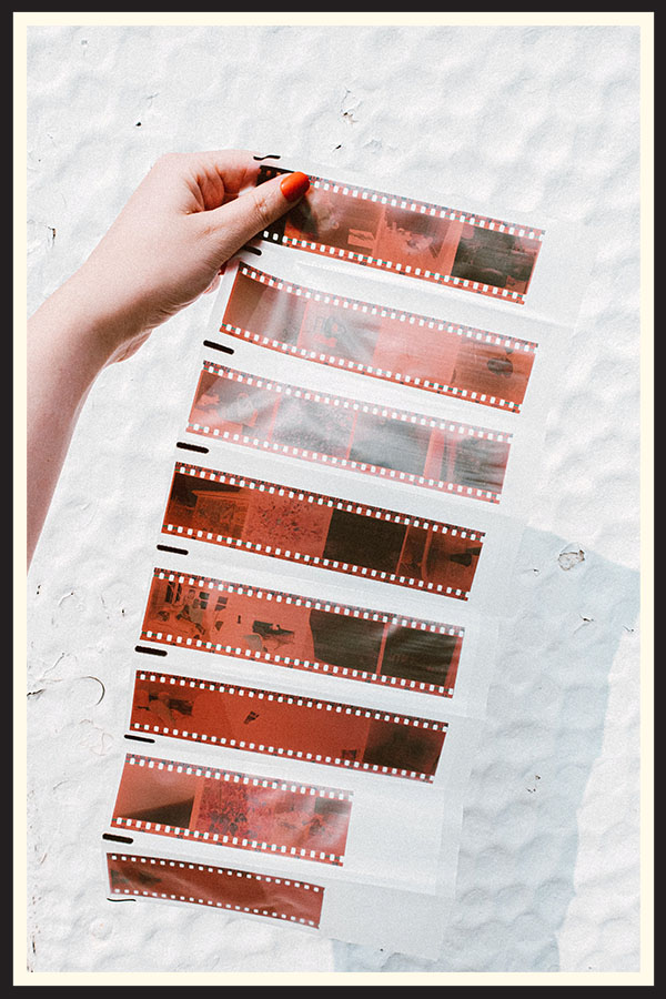 Hand holing a sheet of developed 35mm negatives