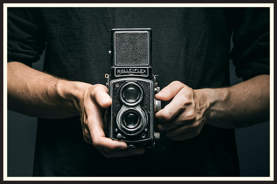 Someone holding a Rolleiflex TLR film camera.