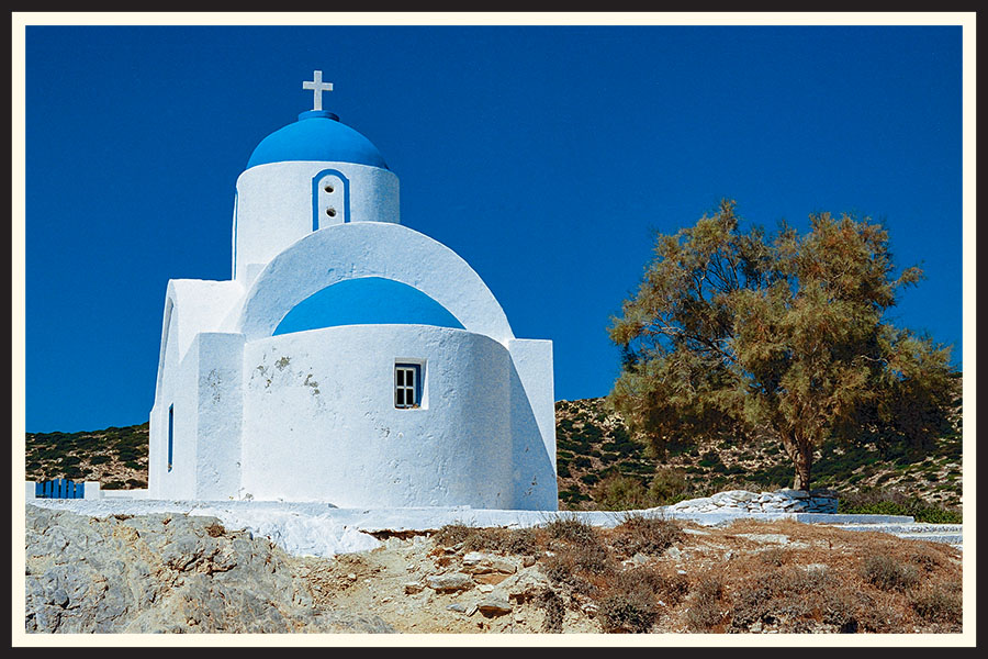 A small church against a backdrop of a bright blue sky captured on Kodak Ektar 100.