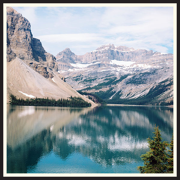Landscape photo of Bow Lake with mountains reflecting in the water, taken on Kodak Ektar 100 film.