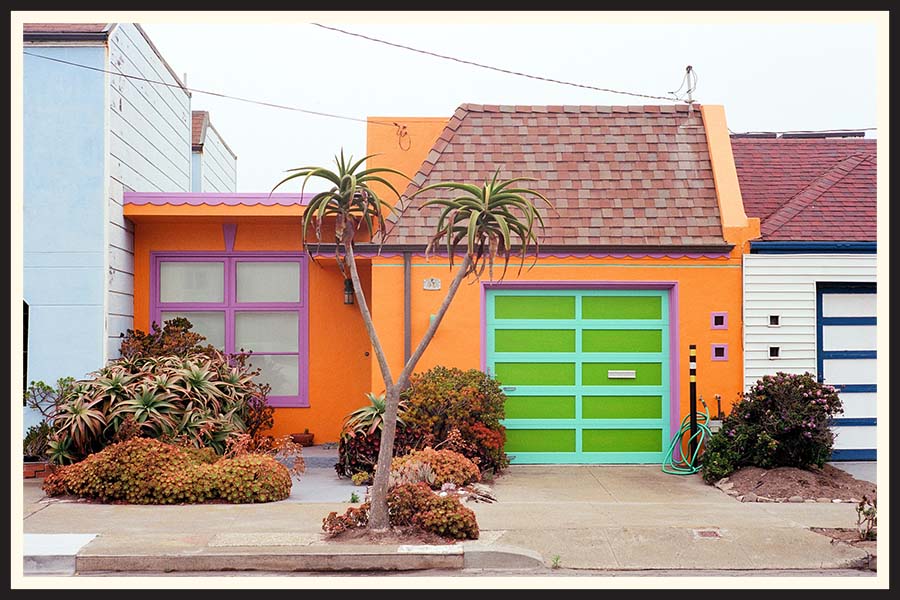 A bright orange house with brightly painted accents, taken on Kodak Ektar 100 film.