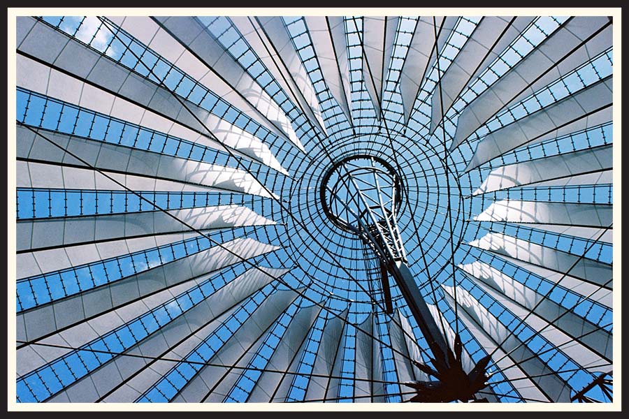 Film photo of a geometric window with blue skies behind on Kodak Ektar 100 film.
