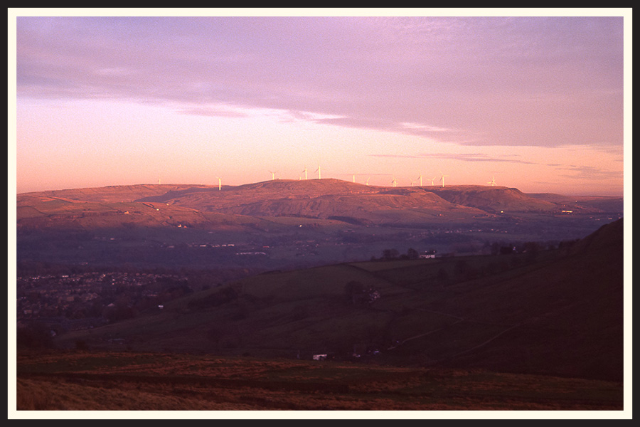 Film photo of a pink sunset over a mountain, taken on a  Canon Sure Shot 35mm camera.
