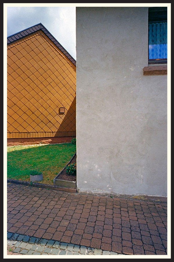 Wide angle, film photo of two buildings taken on a Contax G2 camera