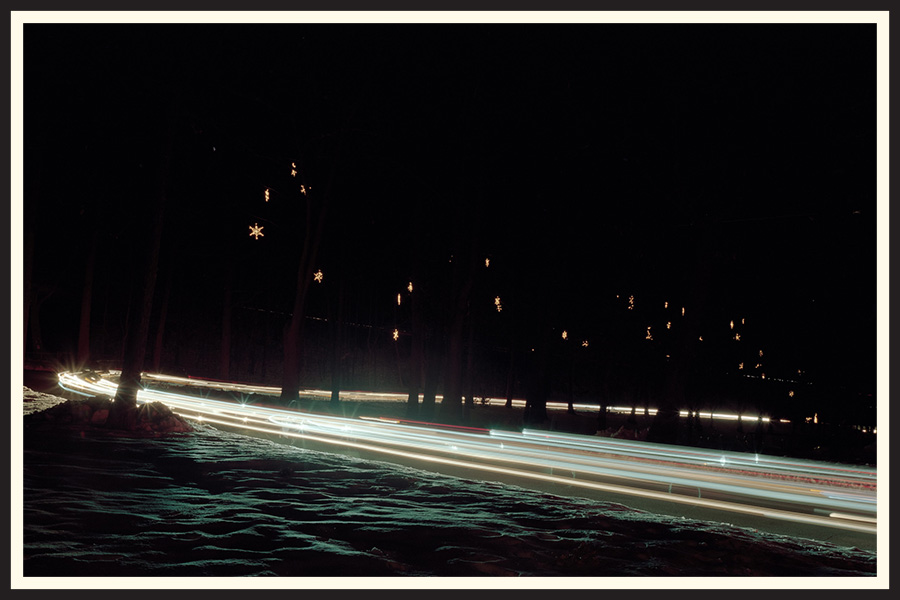 Film photo of a car's light trails with snow on the ground, taken on Portra 800.