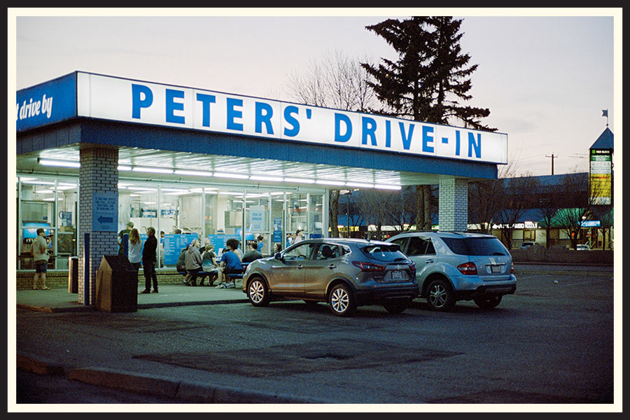 A bright sign reading "Peter's Drive-In" at sunset, taken on Portra 800 film.